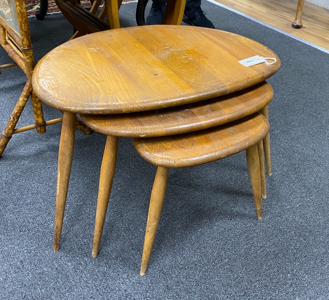 A nest of three Ercol light elm and beech 'pebble' tables, width 65cm, depth 42cm, height 40cm